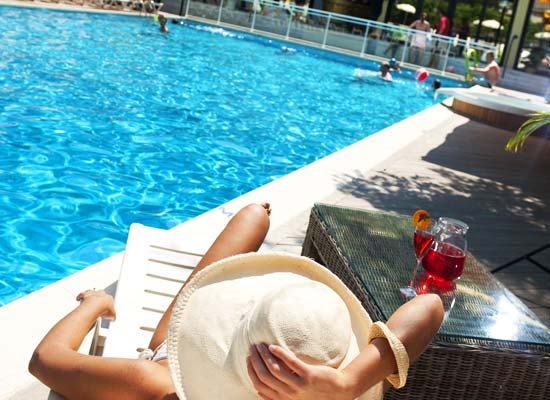 Woman relaxing by the pool